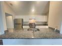 Modern kitchen with granite countertops and stainless steel appliances at 12703 Whiterapids Dr, Orlando, FL 32828