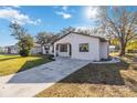 Newly renovated house with a stone facade and a well-manicured lawn at 137 Scott Dr, Sanford, FL 32771