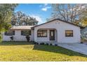 Newly renovated house with a stone facade and a well-manicured lawn at 137 Scott Dr, Sanford, FL 32771