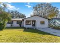 Newly renovated house with a stone facade and a well-manicured lawn at 137 Scott Dr, Sanford, FL 32771