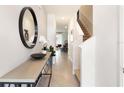 Bright and airy entryway with a modern console table and large mirror at 1527 Isleta Loop, Kissimmee, FL 34741