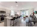 Open concept kitchen with granite countertops and stainless steel appliances at 1527 Isleta Loop, Kissimmee, FL 34741