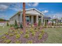 One-story home with light beige siding and a landscaped yard at 1688 Blue Lagoon Cir, Mascotte, FL 34753
