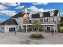 Beautiful two-story home featuring a welcoming front porch and a well-manicured circular driveway at 1730 Connecticut Ave, St Cloud, FL 34769