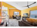 Spacious living room with vaulted ceilings, neutral carpeting, and ample natural light at 290 Clydesdale Cir, Sanford, FL 32773