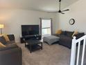 Inviting living room with a large window, neutral carpet, and comfortable sofas at 290 Clydesdale Cir, Sanford, FL 32773