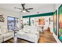 Bright living room open to the kitchen and dining area, featuring stylish furnishings and a sliding glass door at 2935 Antique Oaks Cir # 64, Winter Park, FL 32792
