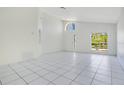 Inviting living room with tile flooring, neutral walls, and large windows provides plenty of natural light at 441 Tree Shore Dr, Orlando, FL 32825