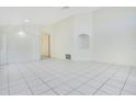 Spacious living room with tile floors, neutral walls, and alcove shelving offers a clean, modern aesthetic at 441 Tree Shore Dr, Orlando, FL 32825