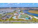 Community aerial view showcasing amenities including a pool, lazy river, mini golf and surrounding homes and landscaping at 4731 Clock Tower Dr # 401, Kissimmee, FL 34746