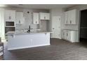 Spacious kitchen featuring white cabinetry, quartz countertops, and herringbone backsplash at 5306 Center Lake Ranch Blvd, St Cloud, FL 34771