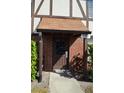 Private condo entry with brown door and brick facade at 5413 Hansel Ave # K10, Orlando, FL 32809