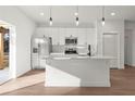 Modern kitchen with stainless steel appliances, white cabinets, and a kitchen island at 6618 Sw 128Th Pl, Ocala, FL 34473