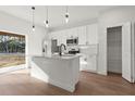 Modern kitchen with stainless steel appliances, white cabinets, and a kitchen island at 6618 Sw 128Th Pl, Ocala, FL 34473