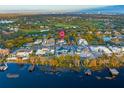 An aerial view of the property, surrounding neighborhood, lake and golf course at 7017 Via Carmel Way, Orlando, FL 32819