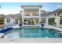 The backyard boasts a sparkling pool and ample patio space, perfect for outdoor relaxation at 7017 Via Carmel Way, Orlando, FL 32819