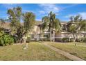 Two-story townhome with a landscaped yard and walkway at 1135 Madeira Key Way Way, Orlando, FL 32824