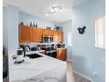 Modern kitchen featuring white countertops, stainless steel appliances and track lighting at 136 Pompano Beach Dr, Kissimmee, FL 34746