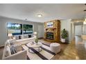 Living room features a stone fireplace and comfy seating at 1361 Peters Dr, Leesburg, FL 34748