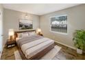 Spacious bedroom with wood-look floors and large window at 1490 Lake Opal Dr, Apopka, FL 32703