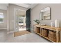 Bright and airy entryway with console table and storage baskets at 15107 Lake Claire Overlook Dr, Winter Garden, FL 34787