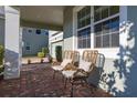 Relaxing front porch with wicker chairs and view of the neighborhood at 15107 Lake Claire Overlook Dr, Winter Garden, FL 34787