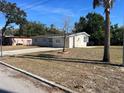 This single-story house boasts a spacious front yard and driveway and has a neutral, modern paint scheme at 1601 Pontiac Ct, Orlando, FL 32808