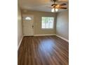Inviting living room with new laminate flooring, a ceiling fan, and an updated front door at 1601 Pontiac Ct, Orlando, FL 32808