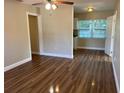 Open-concept living room with new floors offers a bright and airy feel. It leads to an updated kitchen at 1601 Pontiac Ct, Orlando, FL 32808