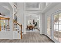 Bright and airy entryway with a staircase, hardwood floors, and a view to the dining room at 1700 Bridlewalk Ct, Gotha, FL 34734
