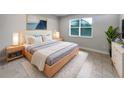 Bright bedroom with a light wooden bed frame and neutral color scheme at 2514 Park Ridge St, Apopka, FL 32712