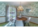 Charming dining room with a round table and chandelier at 400 Magnolia Oak Dr, Longwood, FL 32779