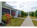Cottage exterior with walkway and tropical landscaping at 421 High Tide Ln, Daytona Beach, FL 32124