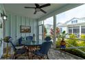 Relaxing screened porch with patio furniture and coastal decor at 421 High Tide Ln, Daytona Beach, FL 32124