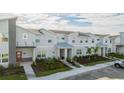 Townhome community featuring multiple units and a parking area at 4447 Scene Ln, Kissimmee, FL 34746