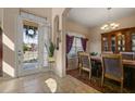 Inviting dining area with tile floors, a chandelier, a china cabinet, and views of the front yard at 4943 Cains Wren Trl, Sanford, FL 32771