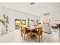 Dining area with wood table and chairs, and sliding glass doors to backyard at 6113 Chorus Dr, Mascotte, FL 34753