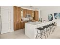 Modern kitchen with white quartz countertops and wood cabinets at 6113 Chorus Dr, Mascotte, FL 34753