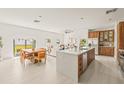 Open concept kitchen with island, wood cabinets, and stainless steel appliances at 6113 Chorus Dr, Mascotte, FL 34753