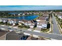 Community view with lake, fountain, and many houses with solar panels at 7613 Wandering Way, Orlando, FL 32836