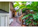 Welcoming entryway with brick and lush tropical plants at 7616 Spring Bay Cv # S, Orlando, FL 32819