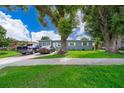 Gray house with a green lawn, two parked cars visible at 901 S Solandra Dr, Orlando, FL 32807