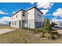 Two-story townhome with gray garage door and partially visible backyard at 984 Desert Candle Dr, Ocoee, FL 34761