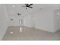 Bright living room featuring tile floors and ceiling fans at 13497 Se 100Th Ave, Belleview, FL 34420