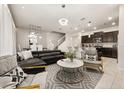 Open living space with a contemporary sectional sofa and modern coffee table at 1366 Lava Tree Dr, Davenport, FL 33897