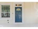 Blue front door entryway with sidelights and a porch at 13730 Lensdale Ln, Windermere, FL 34786