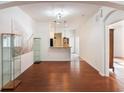 Open living area with hardwood floors and kitchen access at 13730 Lensdale Ln, Windermere, FL 34786