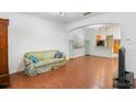 Living room with hardwood floors and view into kitchen at 13730 Lensdale Ln, Windermere, FL 34786
