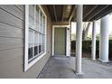 Inviting entryway featuring a green front door with white columns and a large window at 144 Reserve Cir # 112, Oviedo, FL 32765