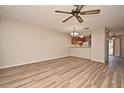 Open-concept living room featuring wood-look flooring and views to kitchen at 144 Reserve Cir # 112, Oviedo, FL 32765